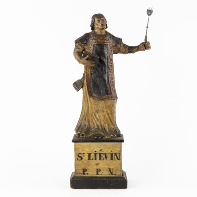 an old statue of a man holding a knife and fork