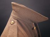 a close up of a coat with buttons on a mannequin