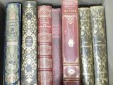 many old books in a box on the shelf