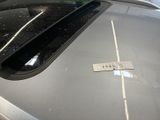 a sticker on the hood of a car that is parked in a parking lot