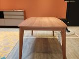 a table that is sitting on a rug in a room