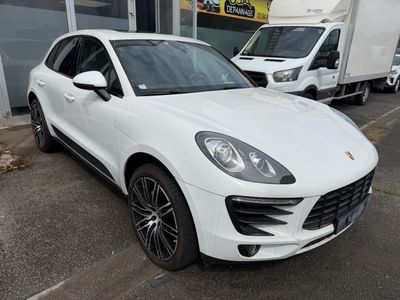 the white porsche cayen is parked in front of a building