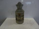 a small metal container on a table with a handle