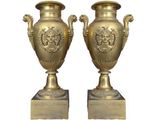 pair of antique brass vases on marble bases on white background