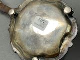 a silver spoon that is sitting on a table