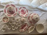 a table with a lot of dishes and cups on it