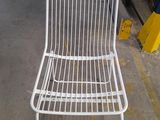 a white chair that is sitting in a garage