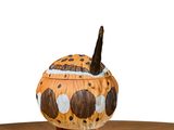 a brown and white animal figurine sitting on a wooden table