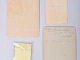 several old papers are sitting on top of a white table