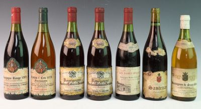 six bottles of wine are lined up in a row on a table