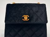 a black chanel bag with gold hardware