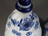 two blue and white vases sitting next to each other on a table