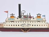 a small model of a boat on a white surface