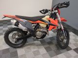 an image of a dirt bike parked on a checkered floor