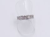 a close up of a ring on a clear ring holder on a white surface