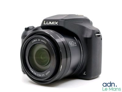 a black camera that is sitting on a white surface