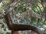 a bronze sculpture of a dog on a wooden stand