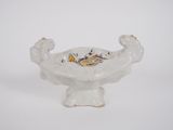 a white bowl with a dragon on it on a white surface