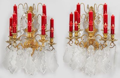 pair of antique brass and crystal wall sconces with red candles