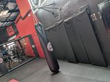 a black punching bag in the middle of a gym