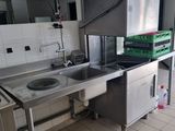 a kitchen with a sink, stove, and refrigerator in it