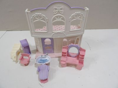 a small doll house with furniture and accessories on the table
