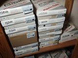 boxes are stacked on top of each other on a shelf in a room