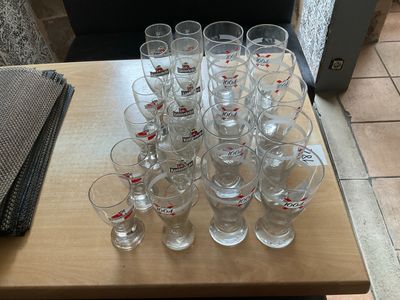 a lot of glasses sitting on a table on the floor