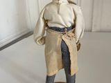 figurine of a man dressed in a white coat and black pants