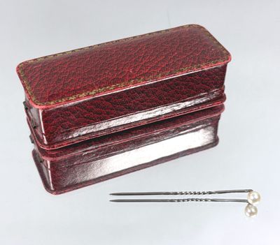 a small red box with a pair of scissors on it