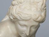 marble statue of a woman with her hands on her head