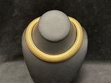 a close up of a necklace on a mannequin on a table
