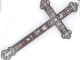 a cross made of wood with a design on it