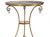a brass table with a glass top and a metal base