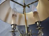 a chandelier that has three lights on it