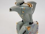 a figurine of a man sitting on top of a suitcase
