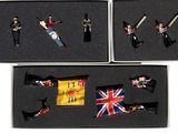 four miniature figurines of soldiers in a box