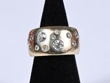 a close up of a gold ring with diamonds on it