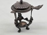 a small metal object with a bird on it