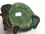 a small green object with a hole in the middle of it