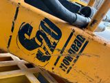 a close up of a yellow construction vehicle with a sign on it