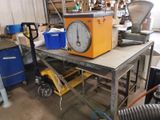 a clock sitting on a workbench in a garage