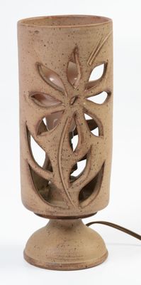 a brown vase with a dragonfly on it on a table