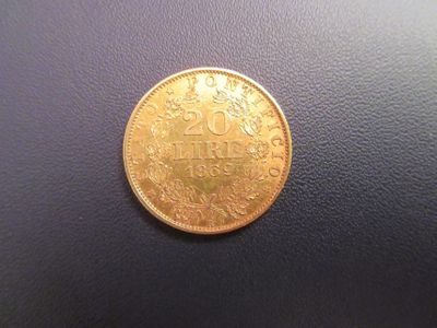a close up of a gold coin on a black surface