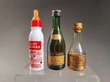 three bottles of alcohol and a bottle of wine on a shelf