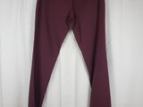 a close up of a pair of maroon pants on a hanger