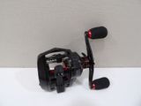 a close up of a fishing reel on a white surface