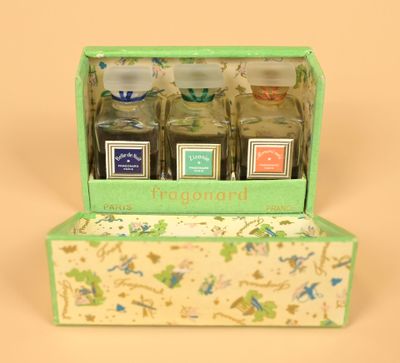 four small bottles of perfume in a green box