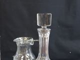 a glass bottle and a decanter sitting on a table