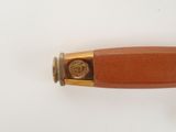 a wooden handle with a gold plate on it